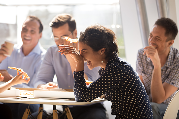 Collègues qui rient ensemble pendant une pause déjeuner conviviale